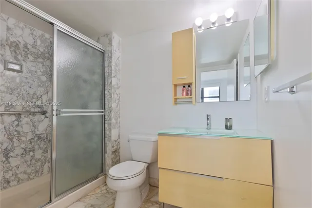 a bathroom with a sink toilet and shower