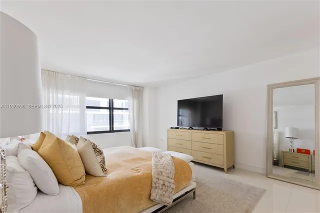 a bedroom with a bed and flat screen tv