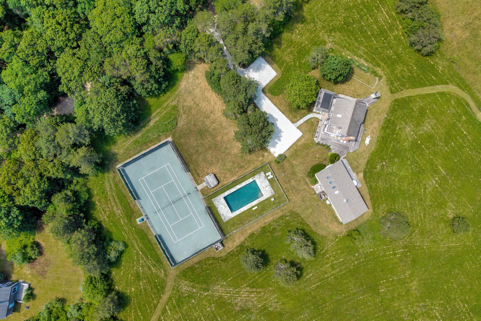 30 Elias Lane West Tisbury, MA 02568 - Photo 3 of 18 30 Elias Lane offers a main house, guest house, pool and private tennis courrt.