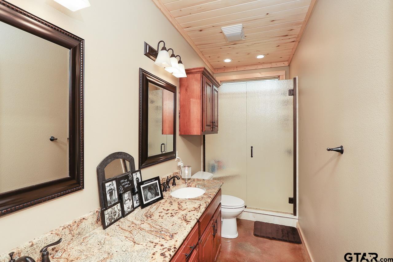 4450 Southwest County Road 3010 Mount Vernon, TX 75457 - Photo 11 of 39 a bathroom with a sink a toilet and shower