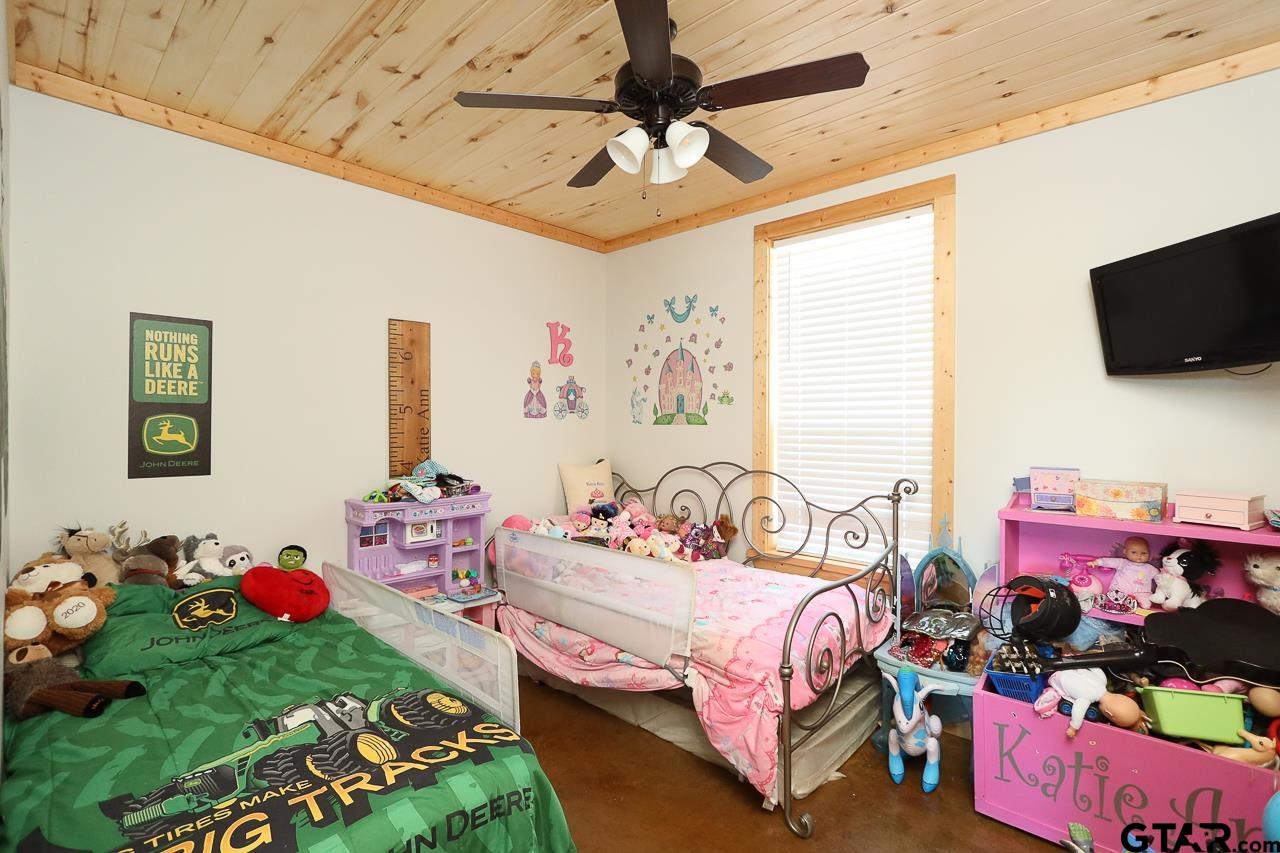 4450 Southwest County Road 3010 Mount Vernon, TX 75457 - Photo 12 of 39 a bedroom with bed and a tv