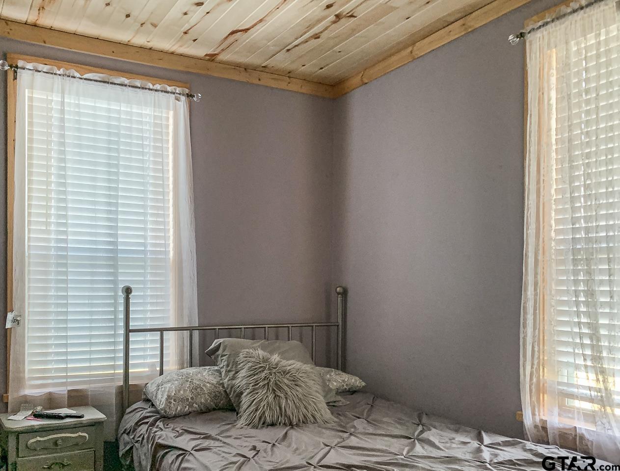 4450 Southwest County Road 3010 Mount Vernon, TX 75457 - Photo 16 of 39 a bedroom with a bed and a window