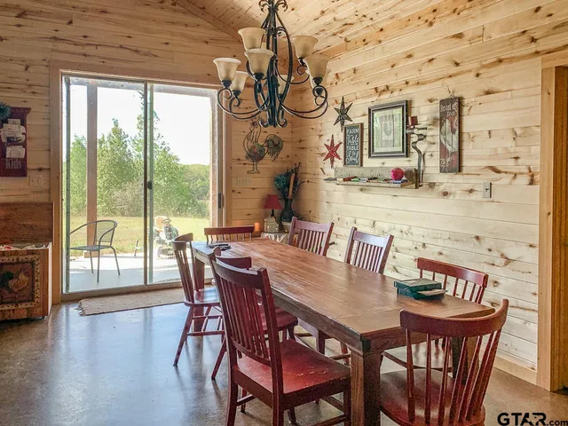 a bedroom with a bed that has a lot of wall paintings on the wall