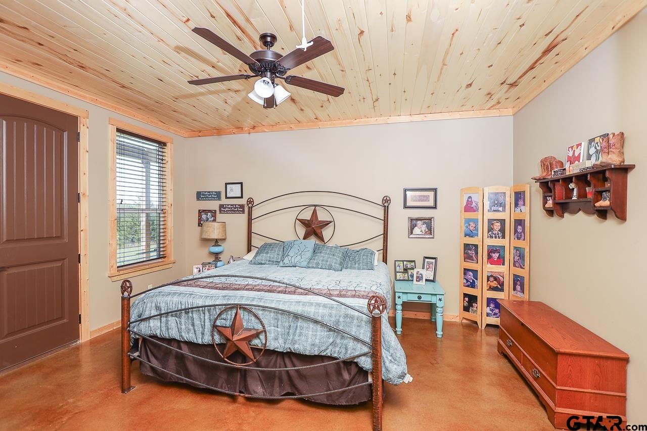 4450 Southwest County Road 3010 Mount Vernon, TX 75457 - Photo 9 of 39 a bedroom with a bed that has a lot of wall paintings on the wall
