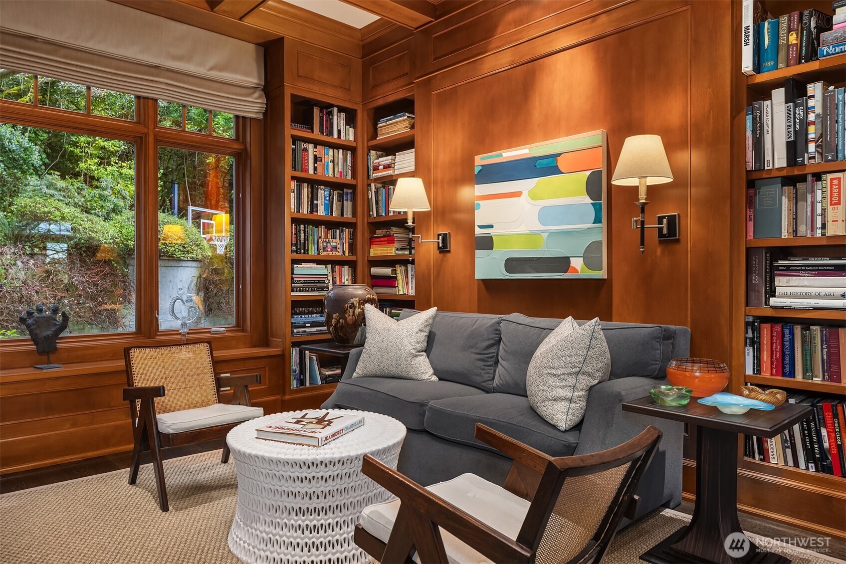 3814 East John Street Seattle, WA 98112 - Photo 5 of 28 a living room with furniture a bookshelf and a large window