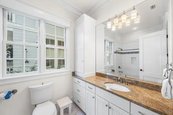 a living room with stainless steel appliances kitchen island granite countertop furniture and a fireplace