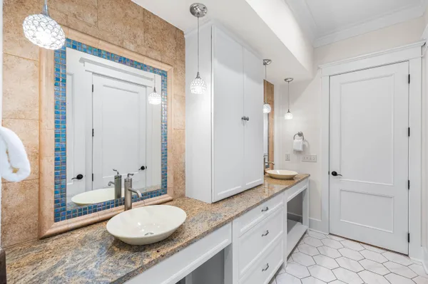 a kitchen with granite countertop white cabinets and white appliances