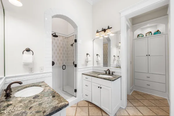 a spacious bathroom with a sink a large mirror and a shower