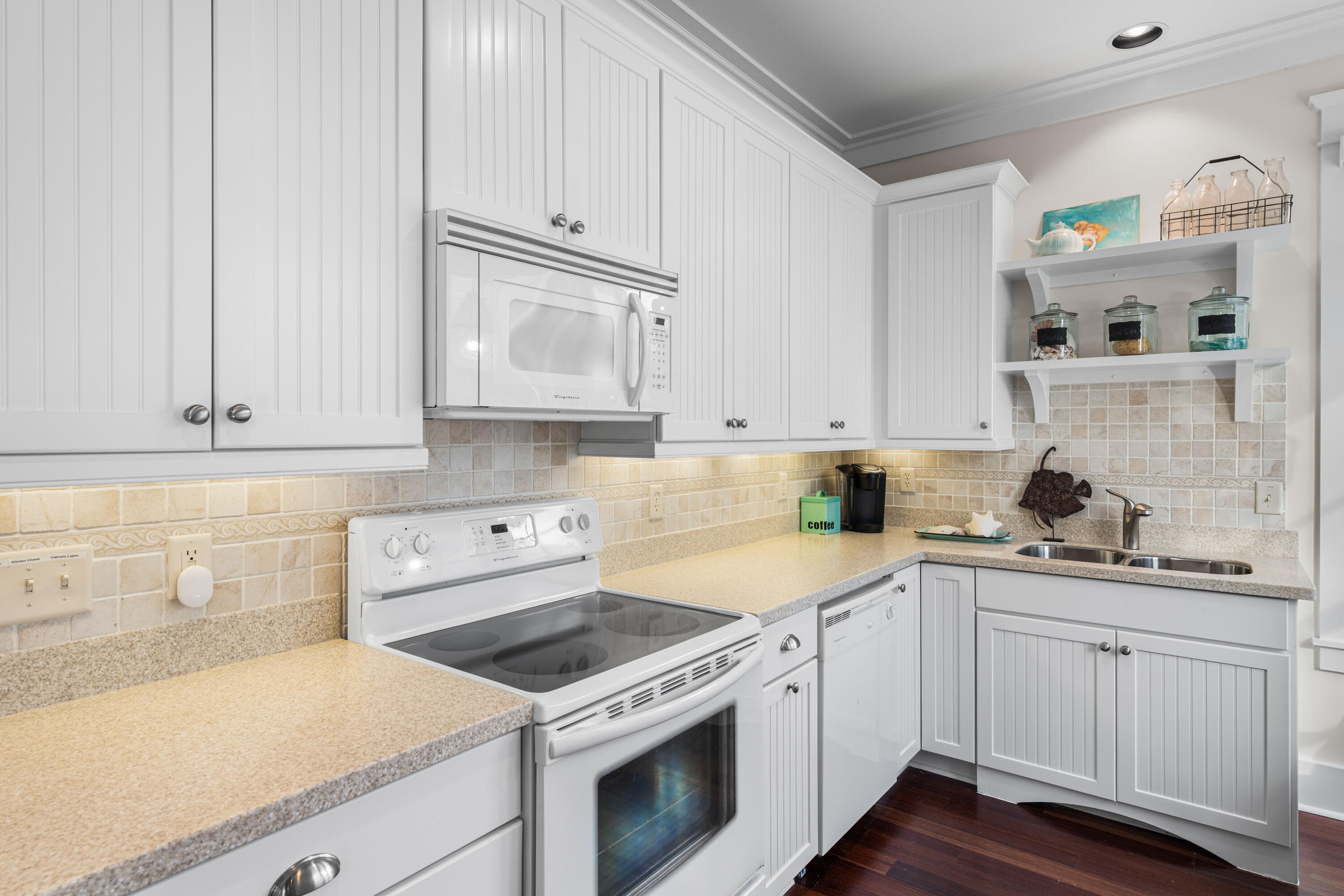 81 Western Lake Drive Santa Rosa Beach, FL 32459 - Photo 66 of 89 a kitchen with granite countertop white cabinets and white appliances