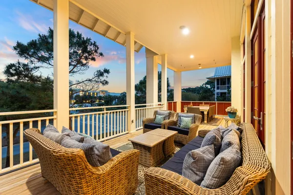 a living room with furniture kitchen view and a large window