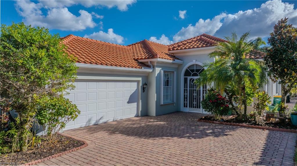 3766 Whidbey Way Naples, FL 34119 - Photo 2 of 50 Mediterranean / spanish home with a tile roof, stucco siding, a garage, and decorative driveway