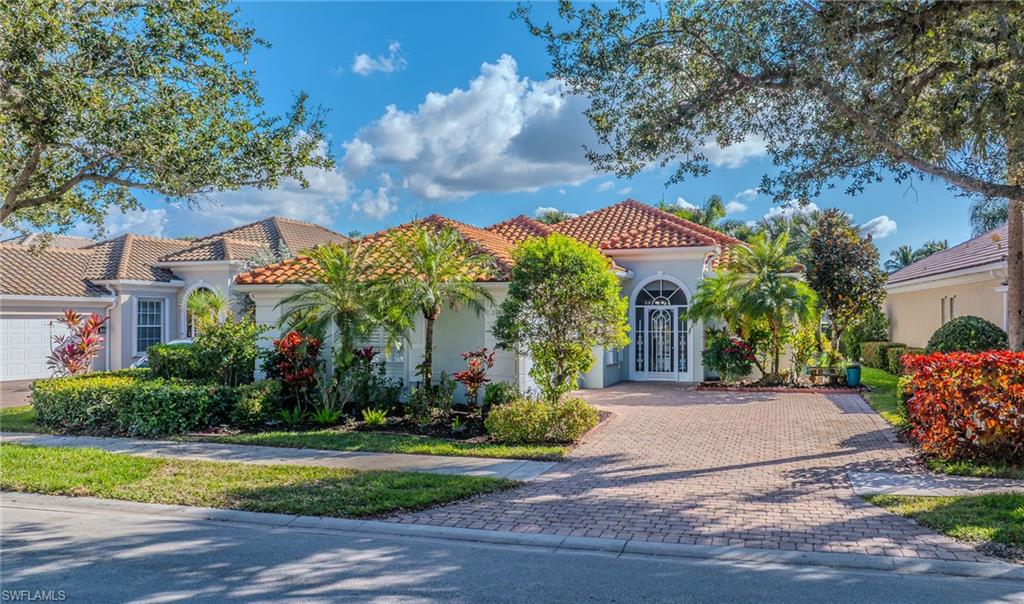 3766 Whidbey Way Naples, FL 34119 - Photo 2 of 50 a front view of house with yard and green space
