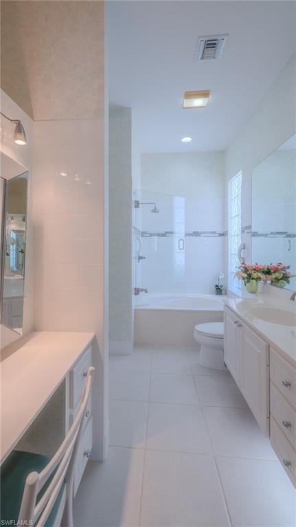 3766 Whidbey Way Naples, FL 34119 - Photo 22 of 50 Full bath with vanity, light tile patterned floors, and tile walls