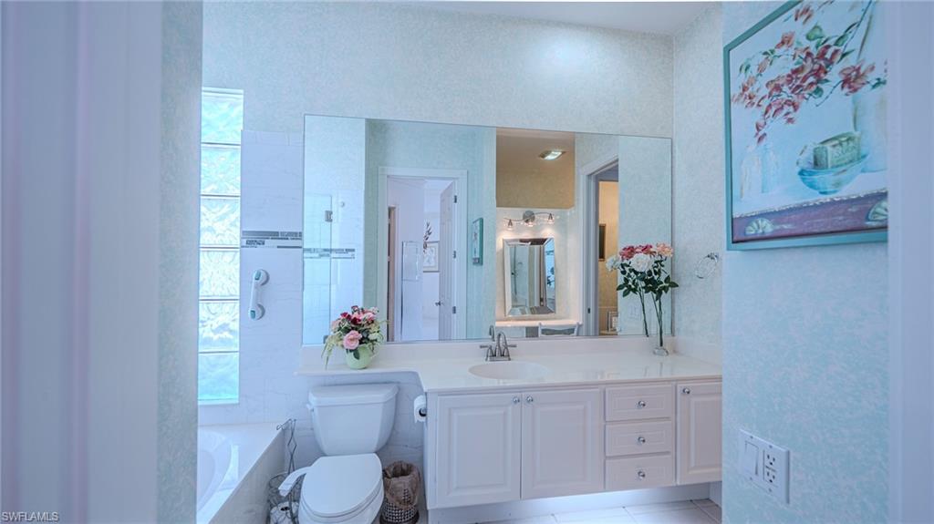 3766 Whidbey Way Naples, FL 34119 - Photo 24 of 50 Full bath with a garden tub, vanity, and light tile patterned floors