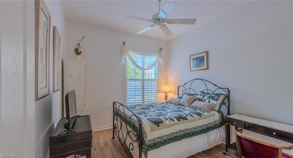 3766 Whidbey Way Naples, FL 34119 - Photo 25 of 50 Bedroom with wood finished floors and a ceiling fan