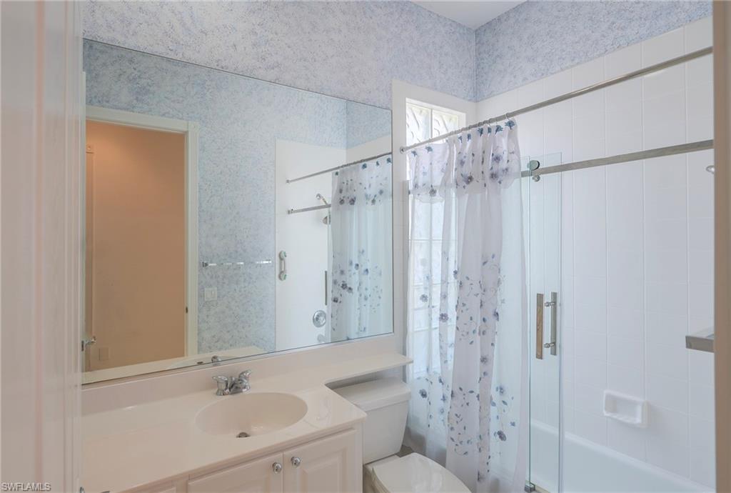 3766 Whidbey Way Naples, FL 34119 - Photo 27 of 50 Bathroom with shower / bath combination with curtain and vanity