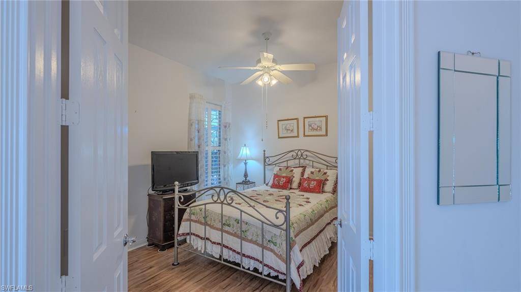 3766 Whidbey Way Naples, FL 34119 - Photo 28 of 50 Bedroom with wood finished floors and ceiling fan