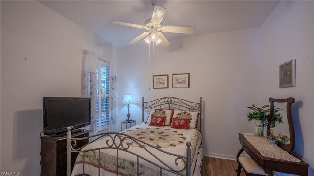 3766 Whidbey Way Naples, FL 34119 - Photo 29 of 50 Bedroom with wood finished floors and ceiling fan