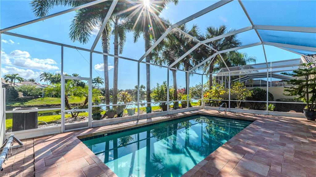 3766 Whidbey Way Naples, FL 34119 - Photo 35 of 50 Outdoor pool with a sunroom and glass enclosure