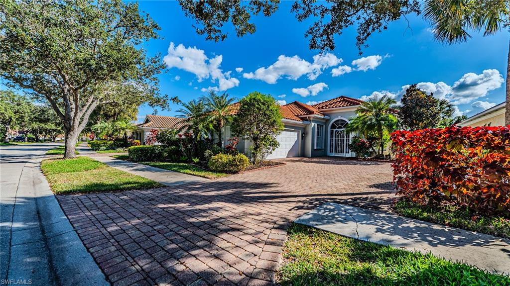 3766 Whidbey Way Naples, FL 34119 - Photo 43 of 50 Mediterranean / spanish house with a tile roof, an attached garage, driveway, and stucco siding