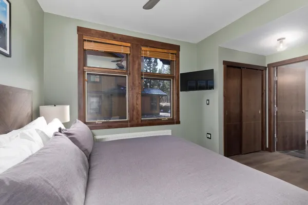 a bedroom with a bed and a large window