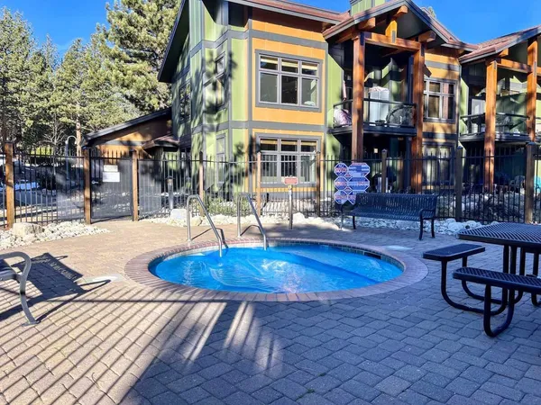 a swimming pool with outdoor seating and yard