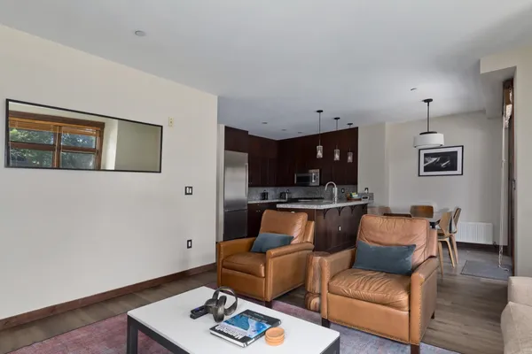 a living room with furniture and wooden floor