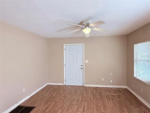wooden floor in an empty room with a window
