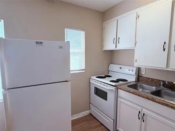a kitchen with a stove and a refrigerator