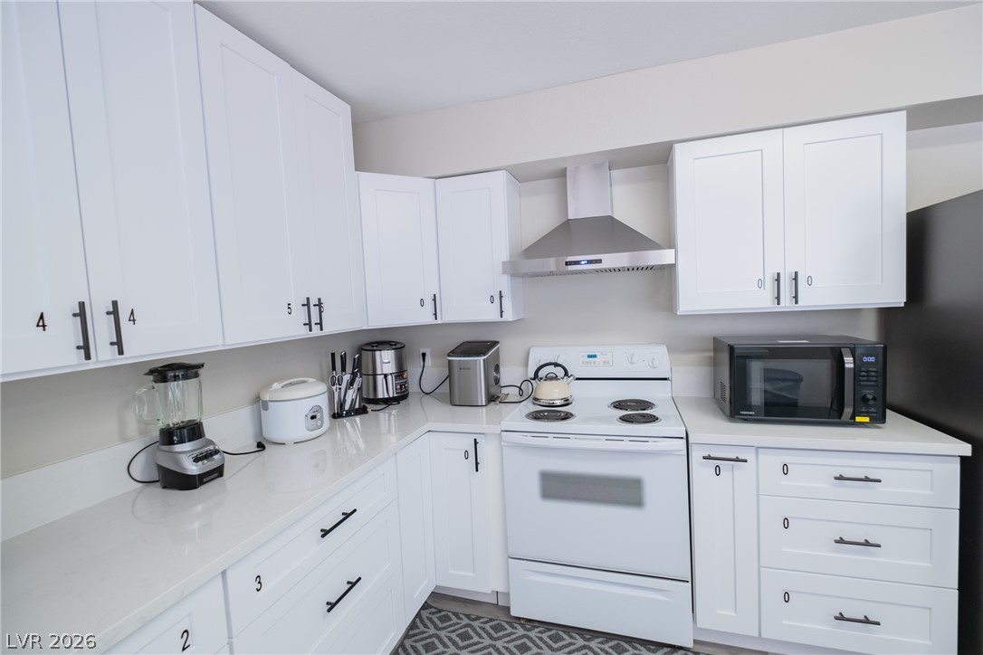6356 West Viking Road Las Vegas, NV 89103 - Photo 17 of 51 Crisp white shaker cabinets pair with solid stone countertops in this updated culinary space.