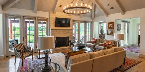 a living room with furniture a window and a flat screen tv