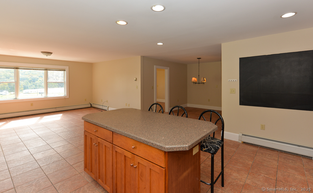 124 Purchase Brook Road Southbury, CT 06488 - Photo 11 of 26 a spacious bathroom with a granite countertop sink a mirror and a bathtub