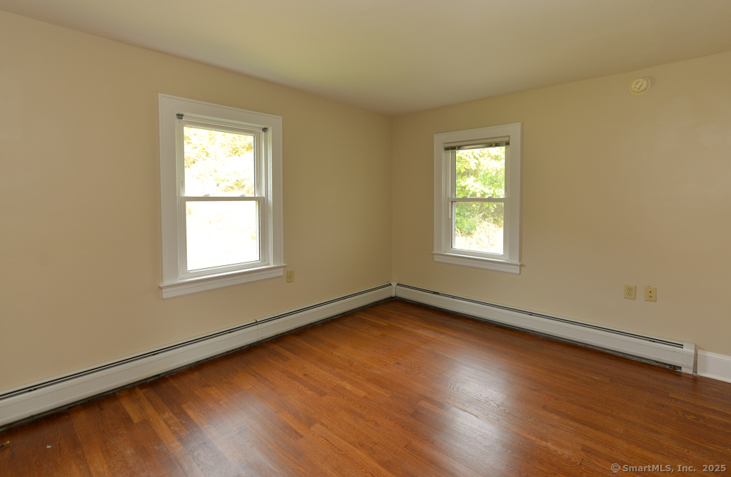 124 Purchase Brook Road Southbury, CT 06488 - Photo 15 of 26 a view of a room with wooden floor and windows