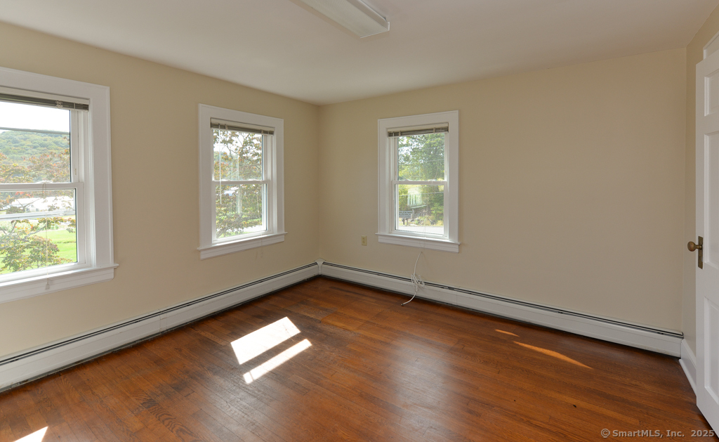 124 Purchase Brook Road Southbury, CT 06488 - Photo 19 of 26 a view of empty room with wooden floor and fan