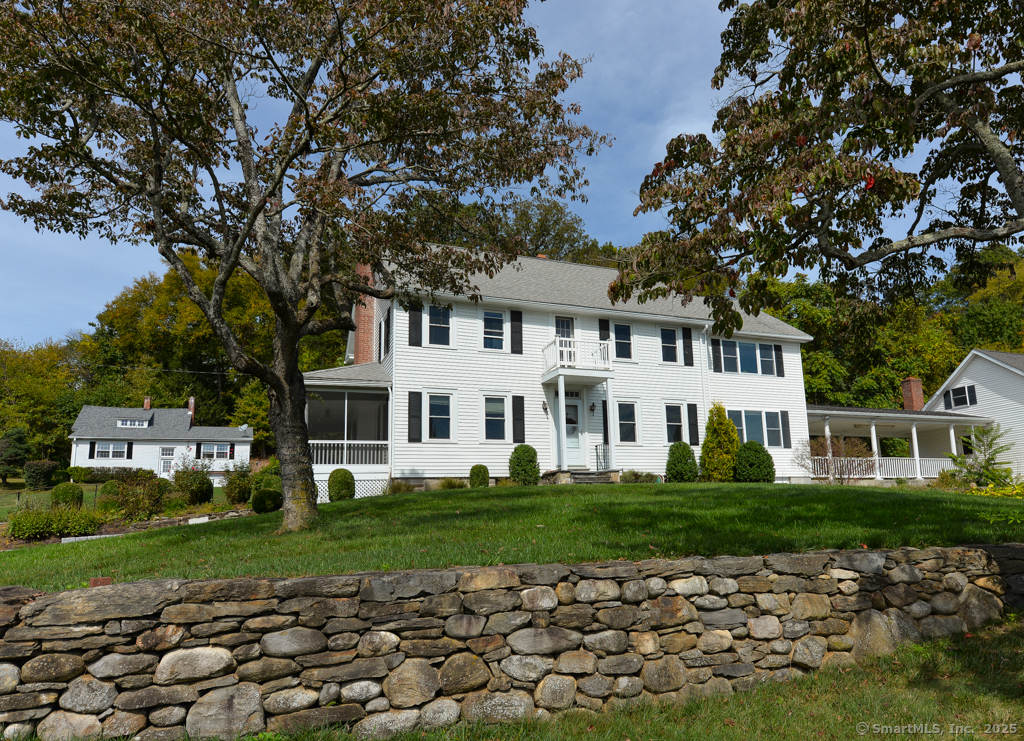 124 Purchase Brook Road Southbury, CT 06488 - Photo 2 of 26 a front view of a house with a garden
