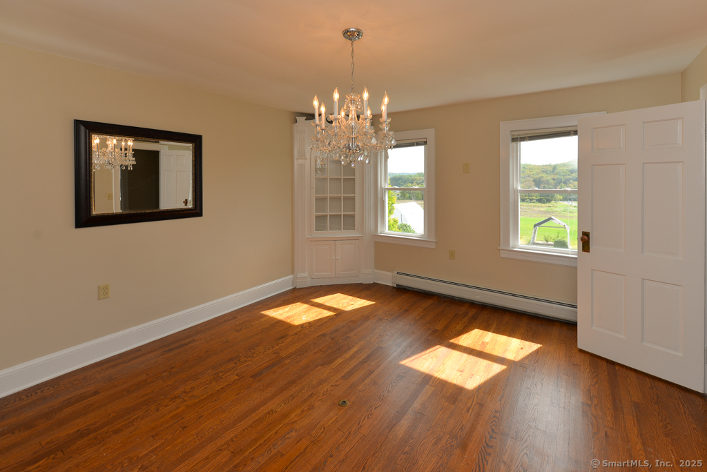 124 Purchase Brook Road Southbury, CT 06488 - Photo 7 of 26 a view of empty room with wooden floor and fan