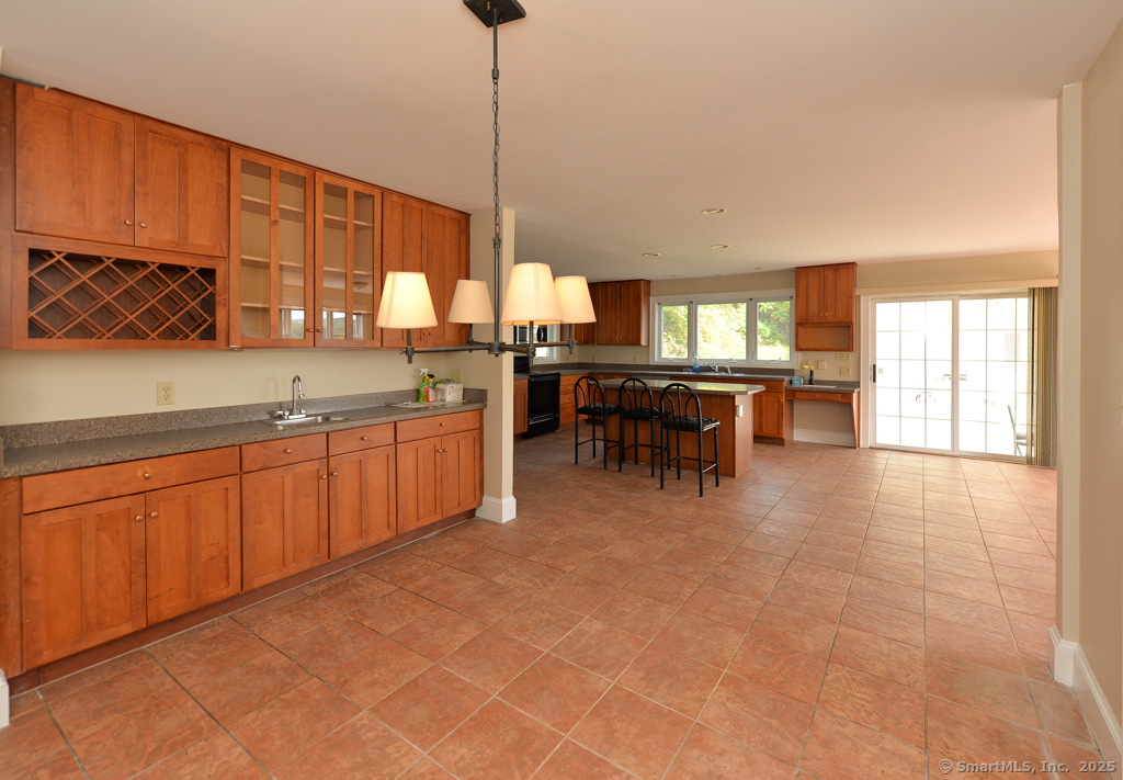 124 Purchase Brook Road Southbury, CT 06488 - Photo 8 of 26 a kitchen with stainless steel appliances granite countertop a sink counter space and a view of living room