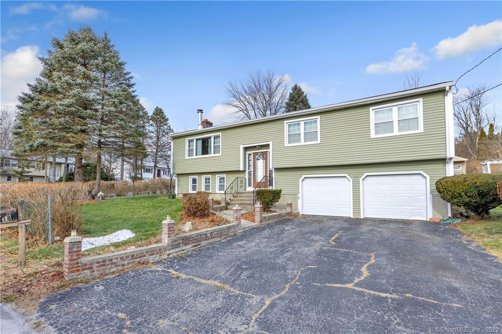 18 Bosse Road Waterbury, CT 06704 - Photo 1 of 1 a front view of a house with a yard and garage