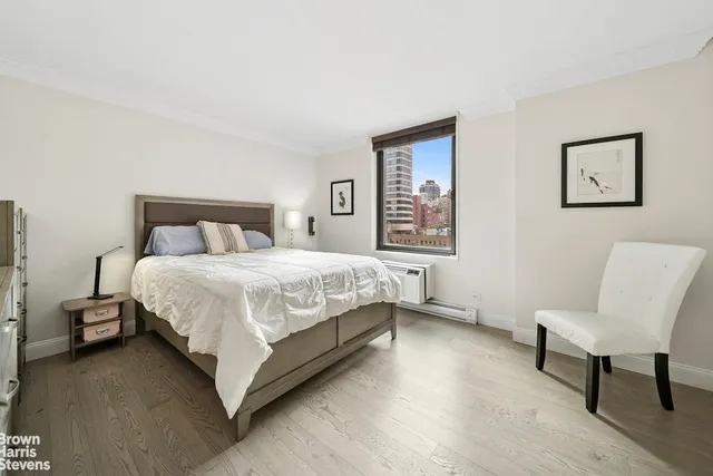 a bedroom with a bed a chair and a couch