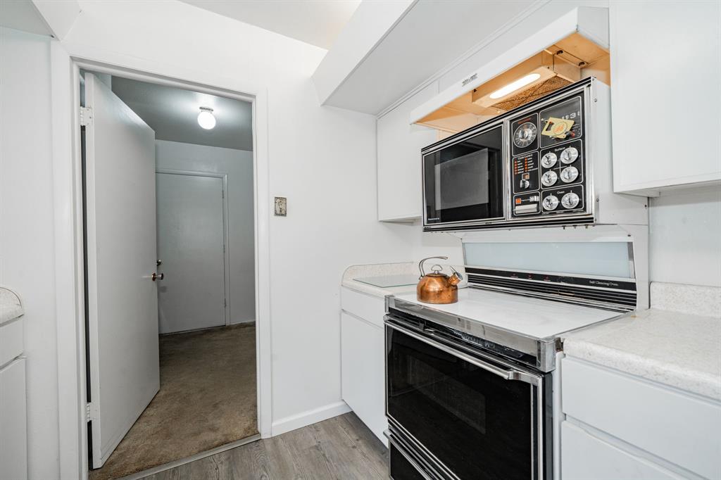 1759 Gross Road Dallas, TX 75228 - Photo 14 of 38 a kitchen with stainless steel appliances granite countertop a stove microwave and sink