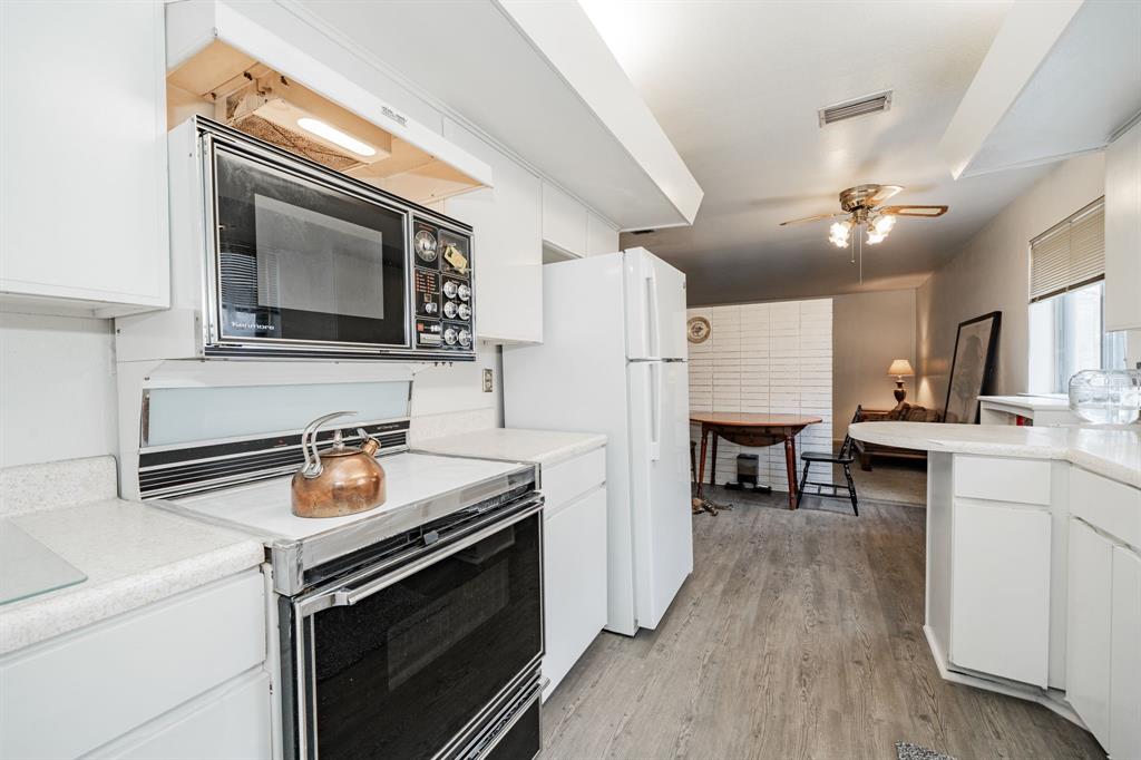 1759 Gross Road Dallas, TX 75228 - Photo 15 of 38 a kitchen with a stove and a microwave