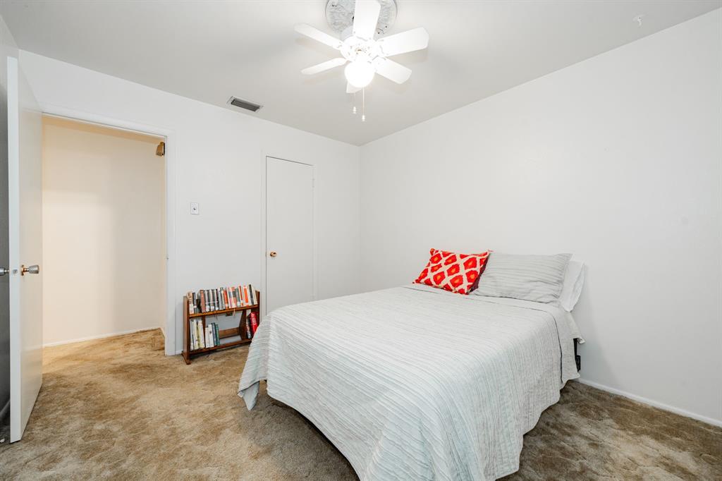 1759 Gross Road Dallas, TX 75228 - Photo 27 of 38 a bedroom with a bed and a chandelier