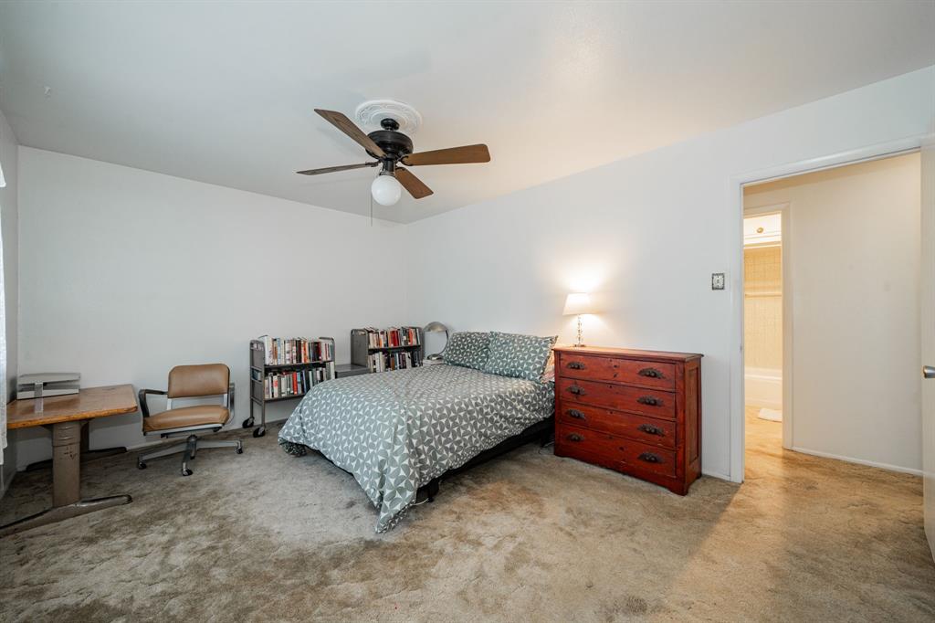 1759 Gross Road Dallas, TX 75228 - Photo 30 of 38 a bedroom with a bed and a chandelier