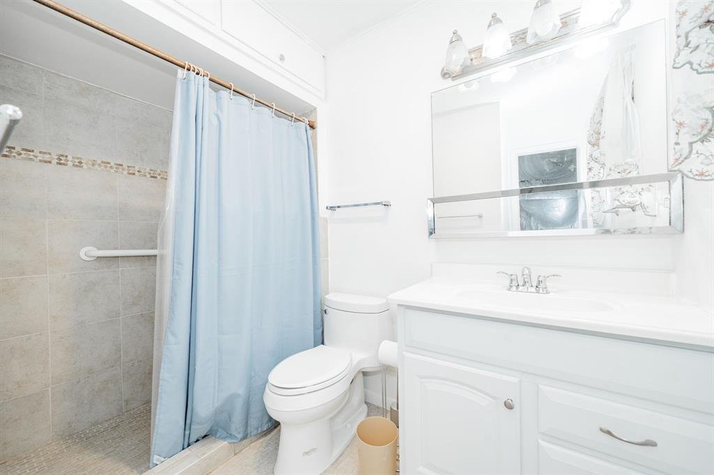 1759 Gross Road Dallas, TX 75228 - Photo 32 of 38 a bathroom with a sink a toilet and shower