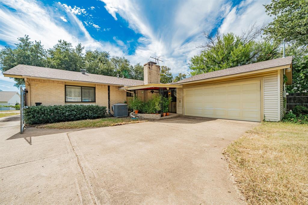 1759 Gross Road Dallas, TX 75228 - Photo 34 of 38 a front view of a house with a yard and garage