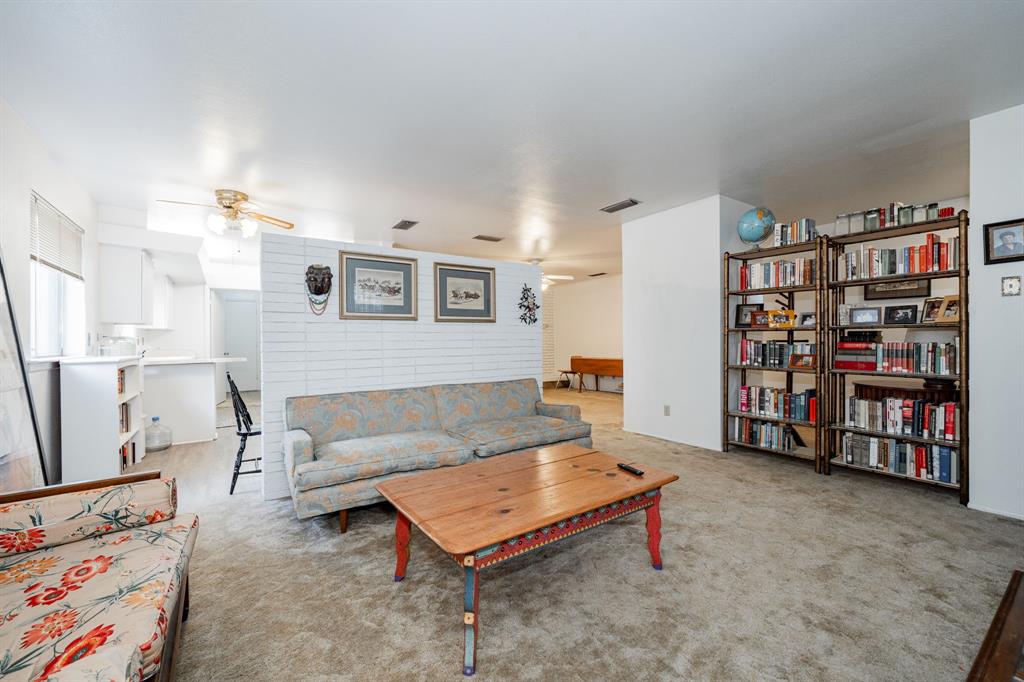 1759 Gross Road Dallas, TX 75228 - Photo 9 of 38 a living room with furniture and a book shelf
