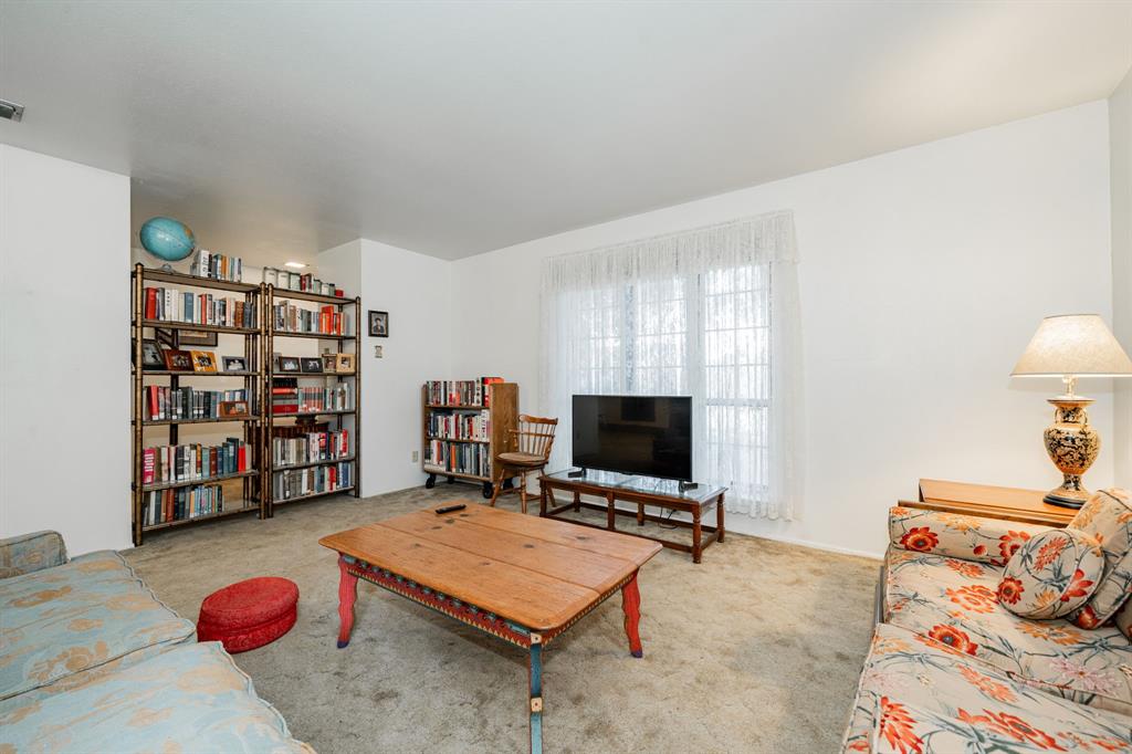 1759 Gross Road Dallas, TX 75228 - Photo 10 of 38 a bedroom with furniture and a book shelf