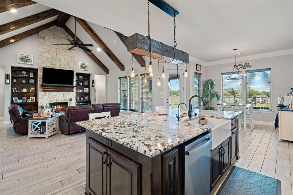 a kitchen with a sink a counter space and wooden floor