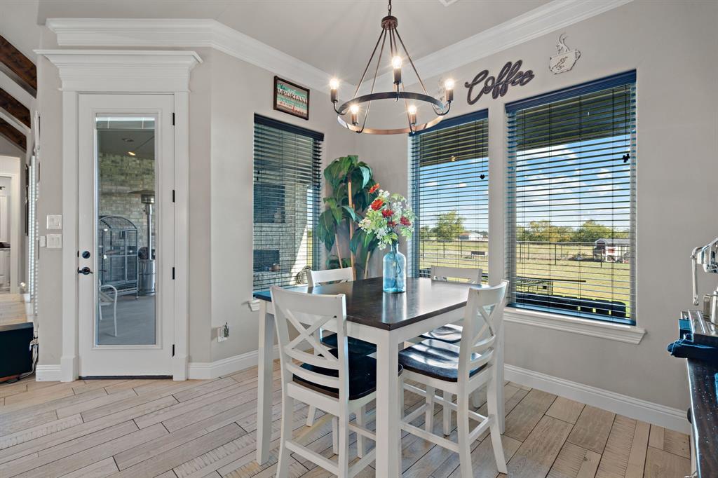 3032 Perkins Weatherford, TX 76088 - Photo 14 of 40 a dining room with furniture a chandelier and wooden floor