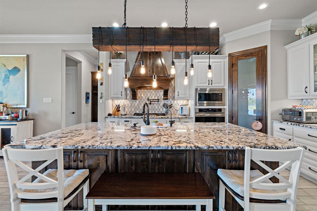 3032 Perkins Weatherford, TX 76088 - Photo 16 of 40 a kitchen with a dining table and chairs